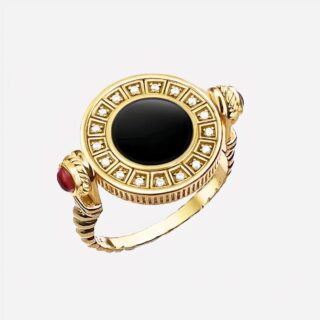 Bague vintage qui tourne dorée avec pierre noire au milieu doré