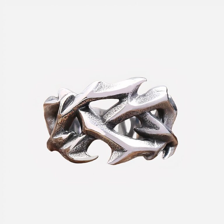 Photo d'une bague argentée pour homme couronne d'épines sur une pierre et un fond marron foncé