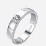 Photo d'une bague homme moderne minimaliste en argent sterling et moissanite sur fond bleu